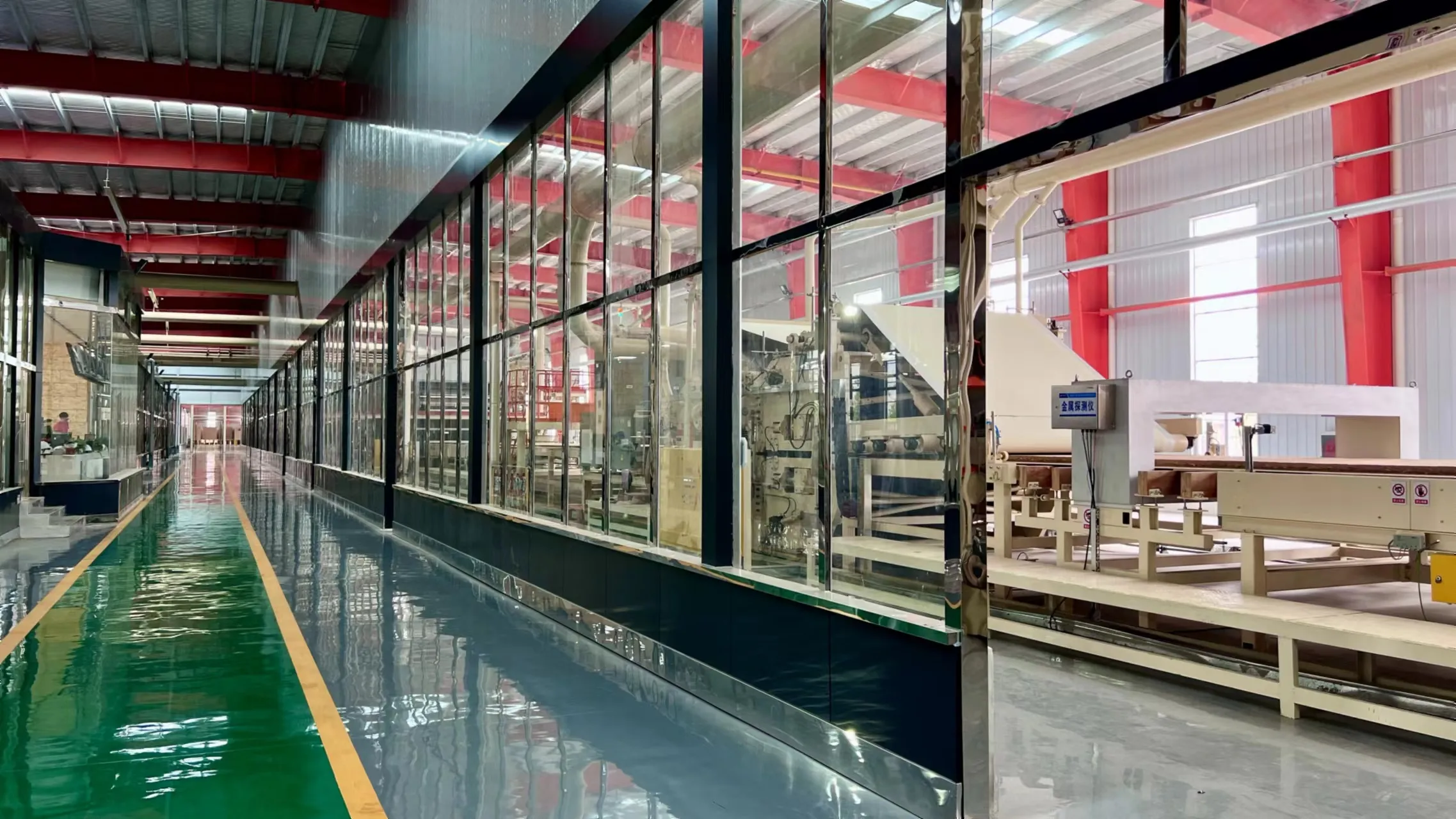 Glass-walled viewing corridor with a metal-detector station and staff visible, at a Ningfeng plant